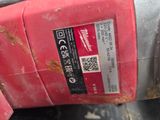 a close up of a red drill with a label on it