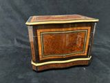 a small wooden box with a decorative design on the front