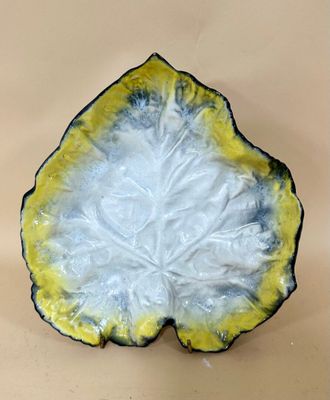 a yellow and white plate with a leaf design on it