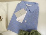 a blue and white striped shirt and a pair of green shoes