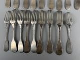 a lot of forks and spoons that are on the table