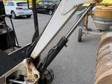 a picture of a tractor with a log on the back of it