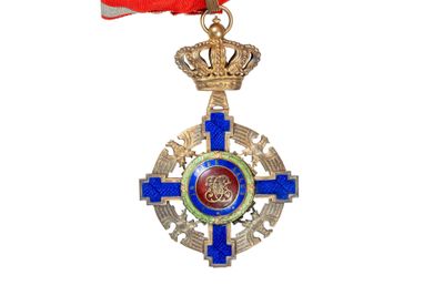 medal with a red ribbon and a crown on a white background