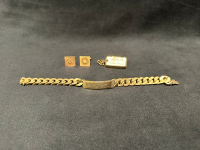 a close up of a gold bracelet and a gold chain