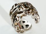 a silver ring that has a dollar sign on it