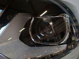a close up of a car ' s headlight on display at a car show