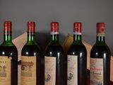 four bottles of wine are lined up in a row on a table