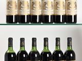 several bottles of wine are lined up on a glass shelf