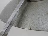 a close up of a metal object with a knife in it