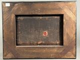 an old wooden picture frame with a red dot in the middle
