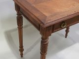 a wooden table with a drawer underneath it