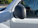 a dog that is sitting in the driver ' s seat of a car