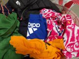 a basket full of clothes sitting on the floor