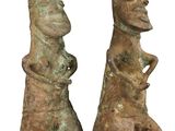 two statues of a man and a woman are standing next to each other