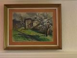 a blurry picture of a living room with paintings on the wall