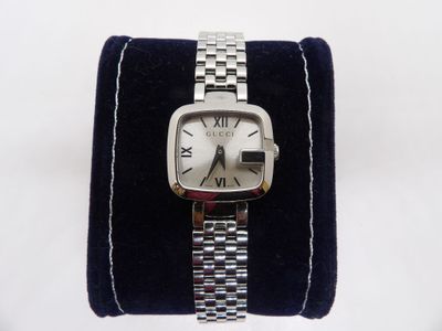 a watch that is sitting on top of a blue velvet case