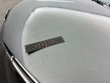 a sticker that says caution on the hood of a car