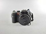 a camera with a lens attached to it on a white surface