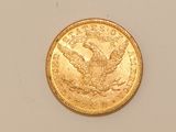 a close up of a gold coin with an eagle on it
