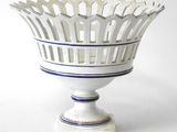 a white vase with a blue stripe around it
