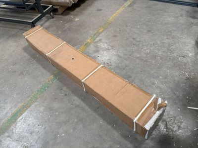 a cardboard box sitting on the floor in a warehouse