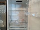 an empty refrigerator with the door open in the kitchen