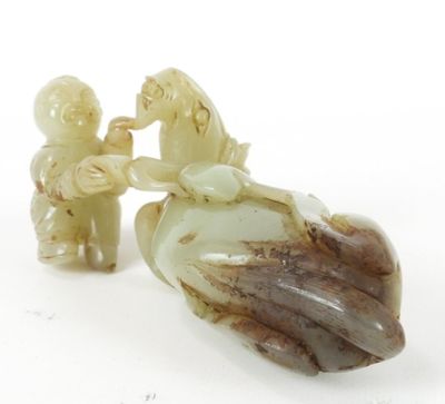 pair of jade figurines of a man and a woman on a horse