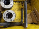 two wrenes and a couple of other tools on a yellow table