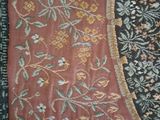 a red and black rug with a floral design on it