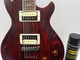an image of a red electric guitar sitting on top of a table