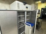 several refrigerators that are in a room with tile flooring