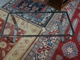 a glass table with a glass top on a rug