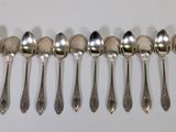 six spoons are lined up in a row on a white surface