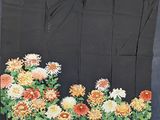 an image of a piece of cloth with flowers and leaves on it