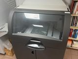 an image of a printer in a room with a book shelf