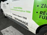 a green and white van parked on the side of the road