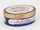 une boîte bleue et dorée ornée de fleurs roses