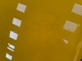 a close up of a toilet with a yellow seat