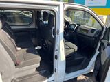 a white van with the door open and the passenger seat down