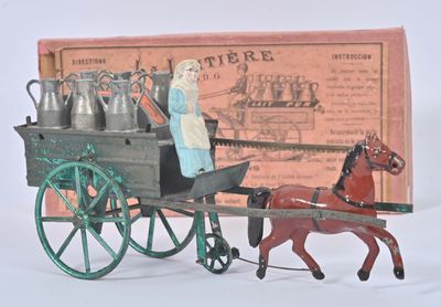 a figurine of a woman riding in a horse drawn carriage