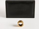 a black box with a gold ring on top of it