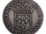 a close up of a coin with a crown on top of it