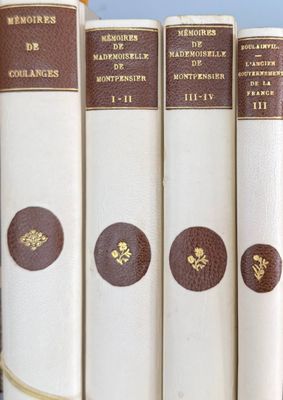 several books are lined up in a row on a shelf