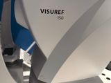 a close up view of a microscope with a monitor in the background