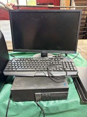 two computers and a laptop sitting on a table