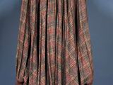 a brown and red plaid coat on a mannequin mannequin stand