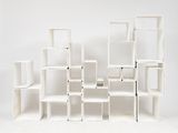 a white shelf that has a lot of cubes on it