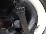 a close up of a helmet with a pair of scissors in it