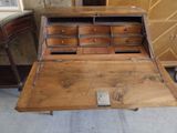 a wooden desk with a drawer on top of it