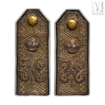 pair of antique brass door handles with a crown on each of them